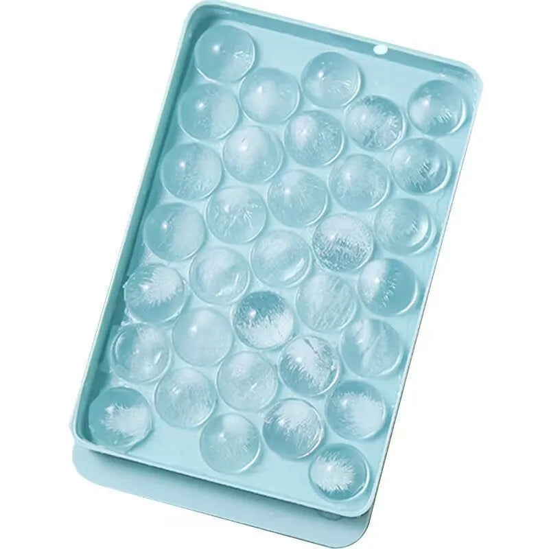 Blue silicone ice cube tray with lid showing 33 round grids for ice making
