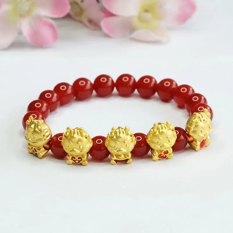 Close-up of a red agate bracelet bead carved with a Chinese Five Blessings Dragon design.