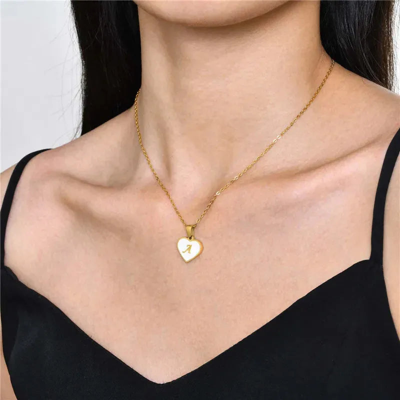 Gold-plated heart-shaped white shell pendant necklace on a stainless steel chain with extendable clasp