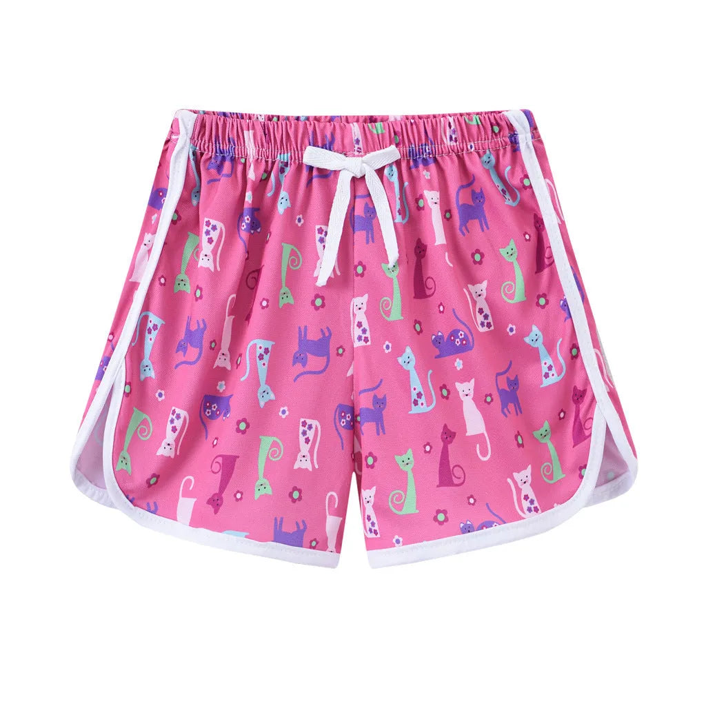 Children's colourful polyester beach shorts showing patterns like leopard print, stripes, and pineapples.