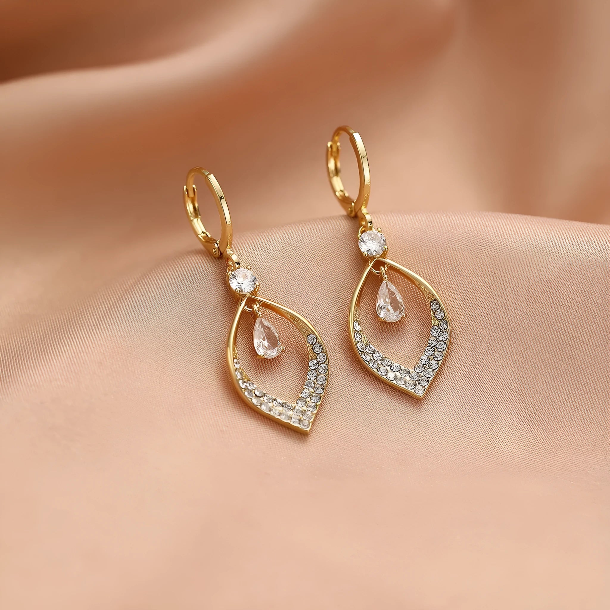 Gold and silver coloured women's teardrop zircon tassel earrings on a copper base.