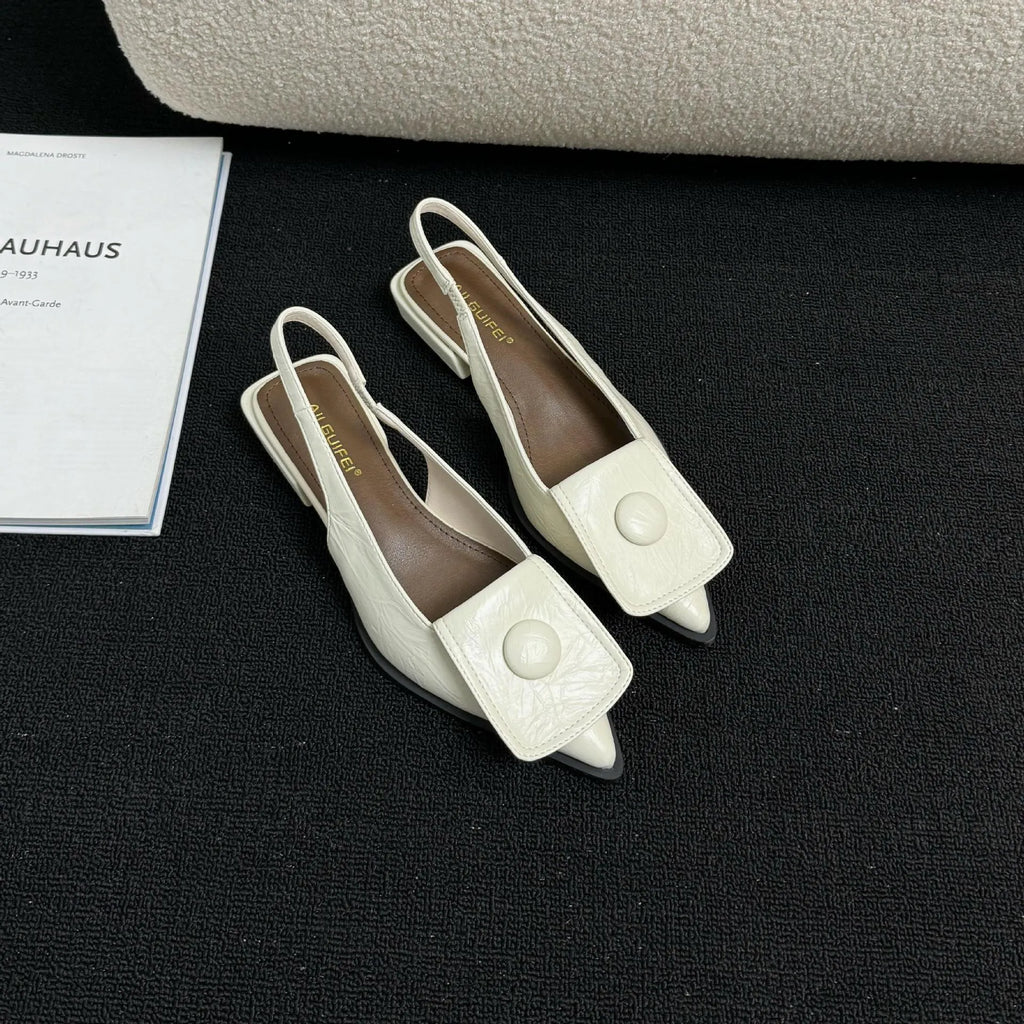 Women's low heel pointed toe sandals with a back strap in black, shown from the side.
