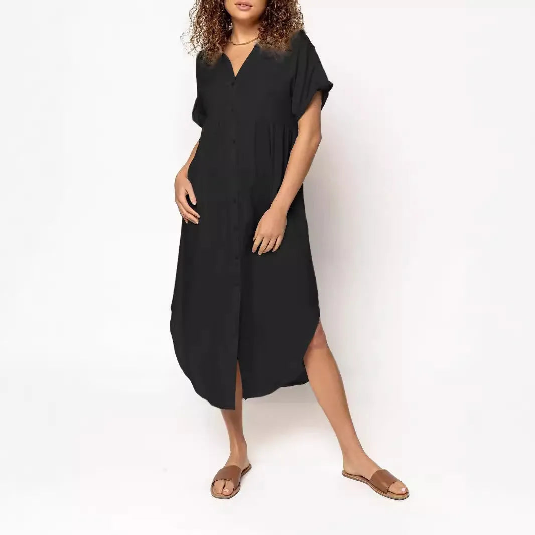 A loose-fitting, solid-colour mid-length casual dress with a front button closure and regular sleeves.