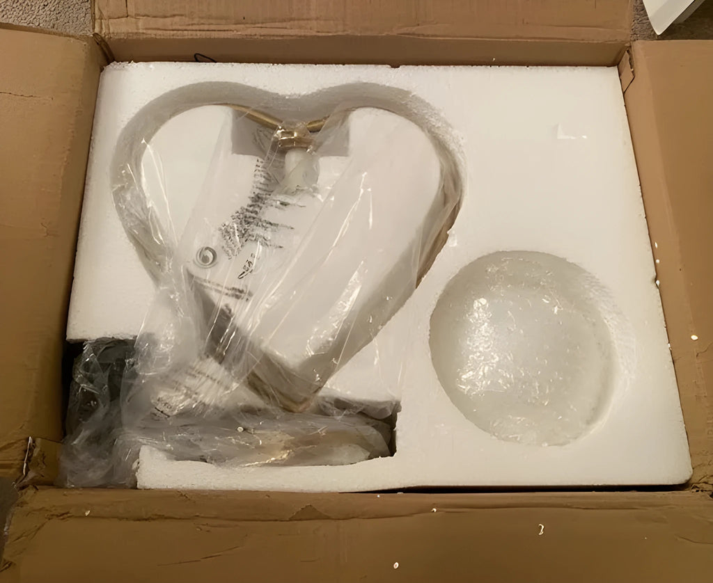 Transparent acrylic heart shaped table lamp with USB cable and dimmer switch on a table.