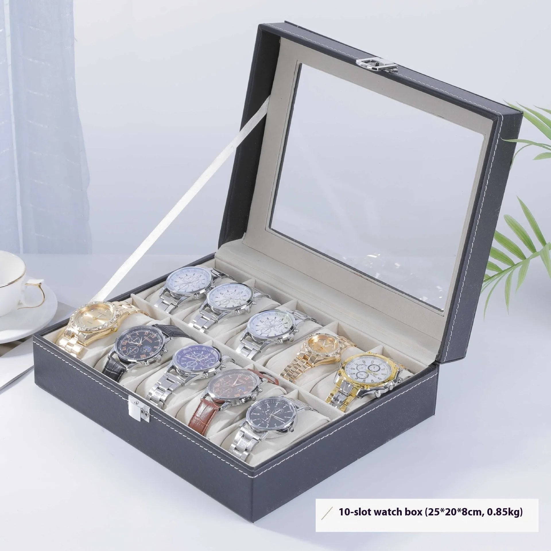 Grey leather watch storage box with transparent lid showing internal watch slots.