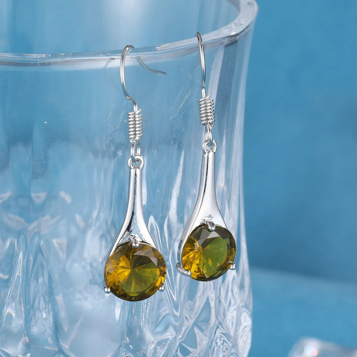 Olive green topaz water drop shaped earrings with electroplated finish and minimalist design