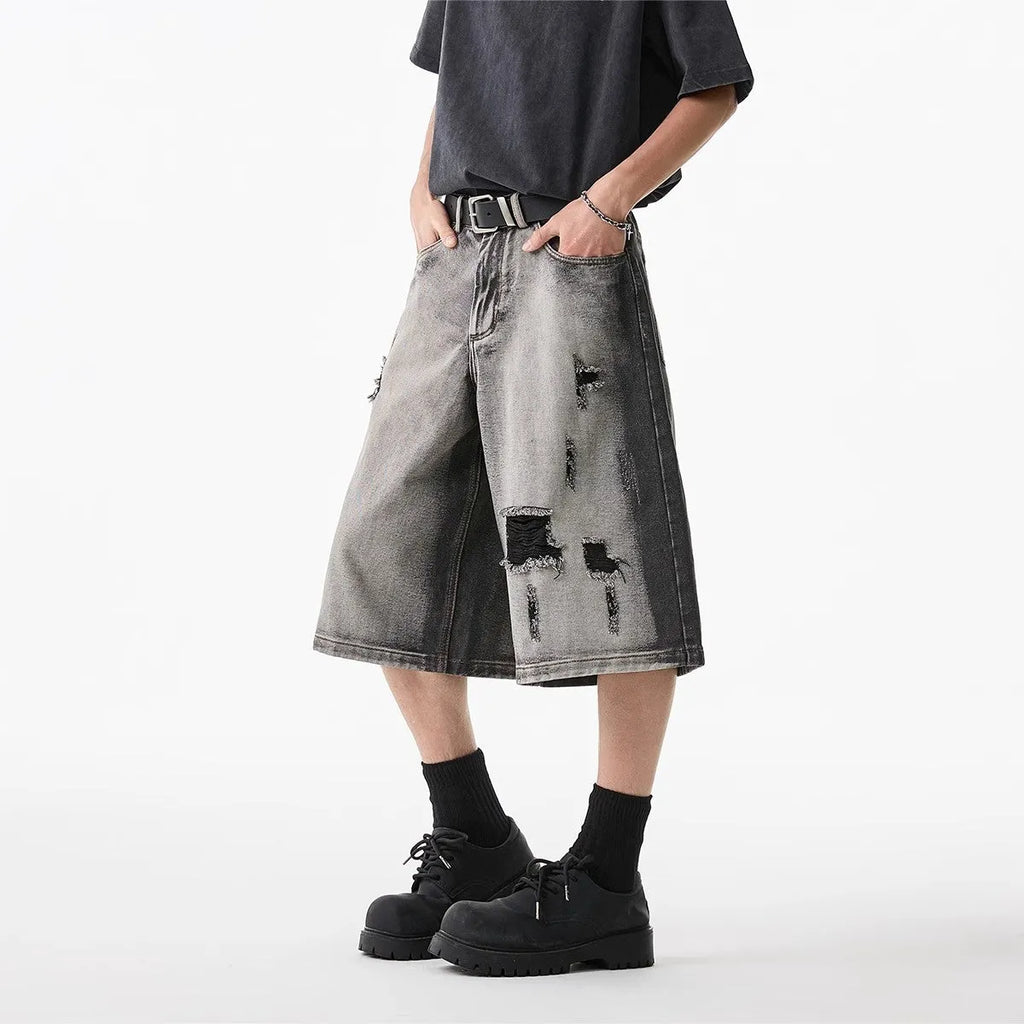 Grey washed denim shorts with distressed holes, loose-fit cropped design for summer casual wear