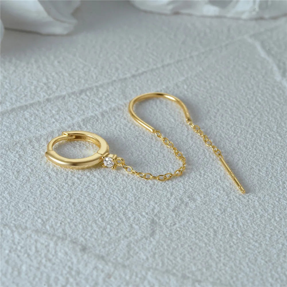 S925 sterling silver ear stud with a geometric diamond flower design and delicate tassel chain detailing in a gold tone finish.