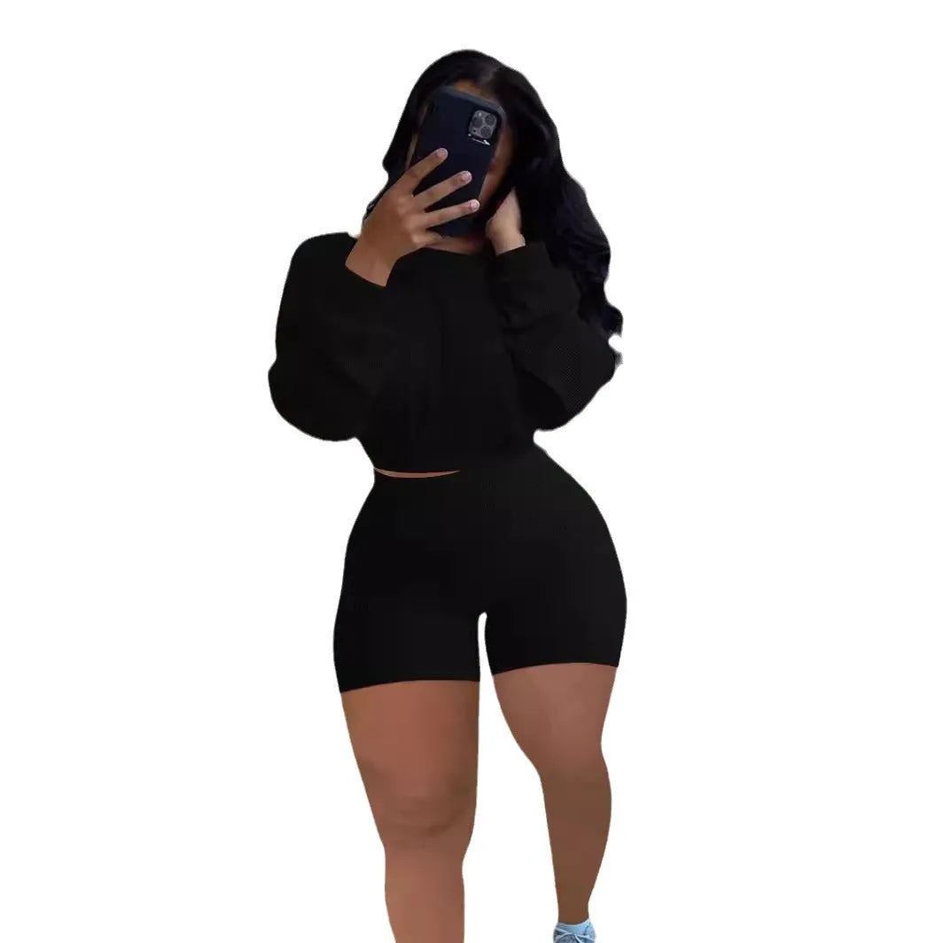 Women's solid colour off-the-shoulder long sleeve top and matching shorts two-piece set.