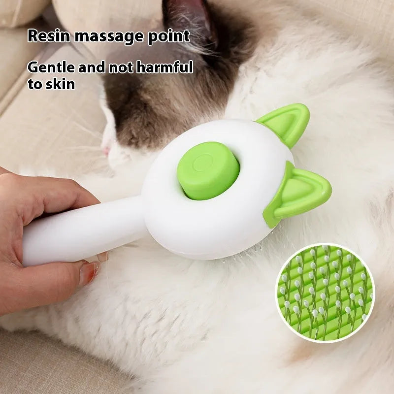 A greenish white and orange cat grooming comb with stainless steel teeth and a self-cleaning button.