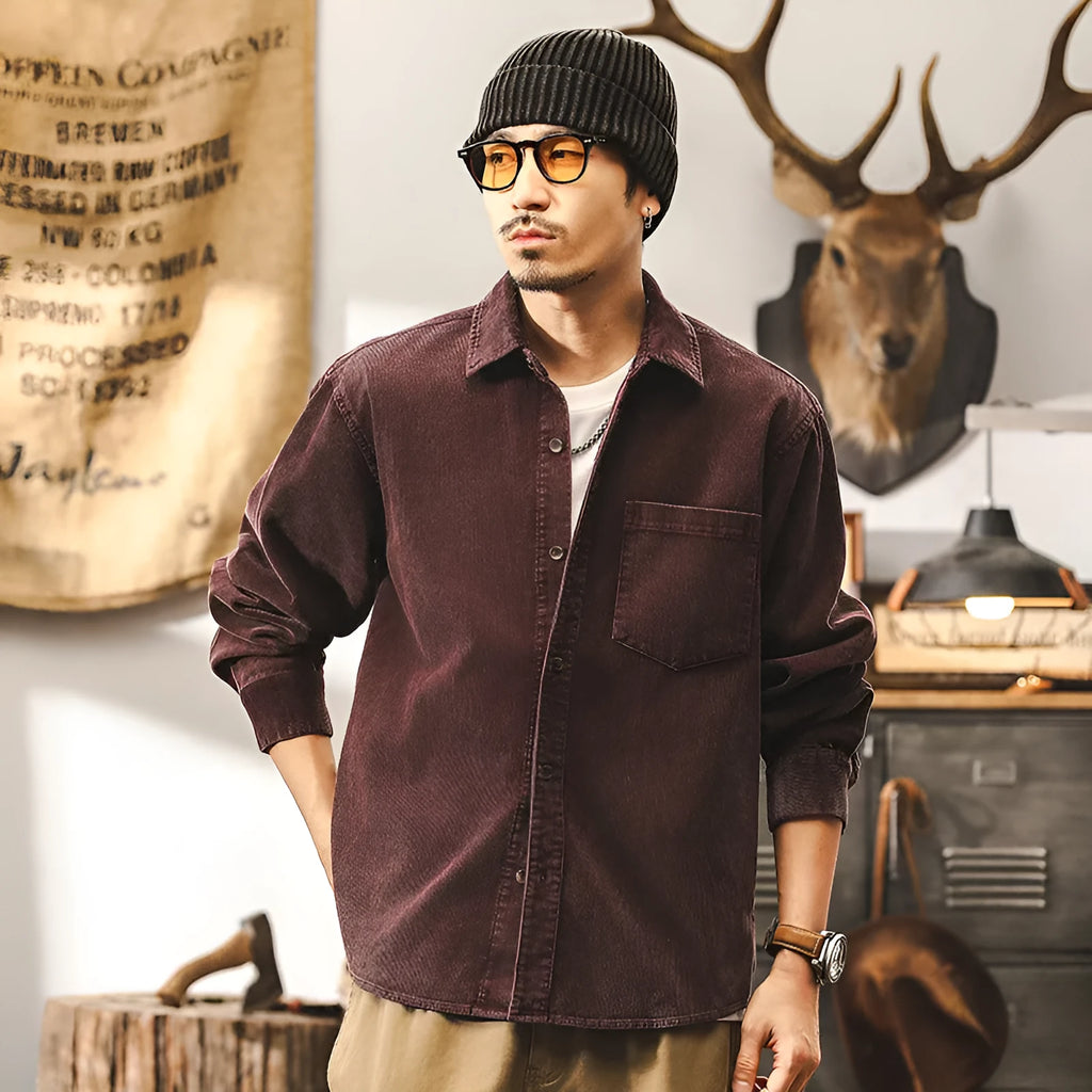 Men's black corduroy shirt jacket with long sleeves and loose retro fit shown unbuttoned