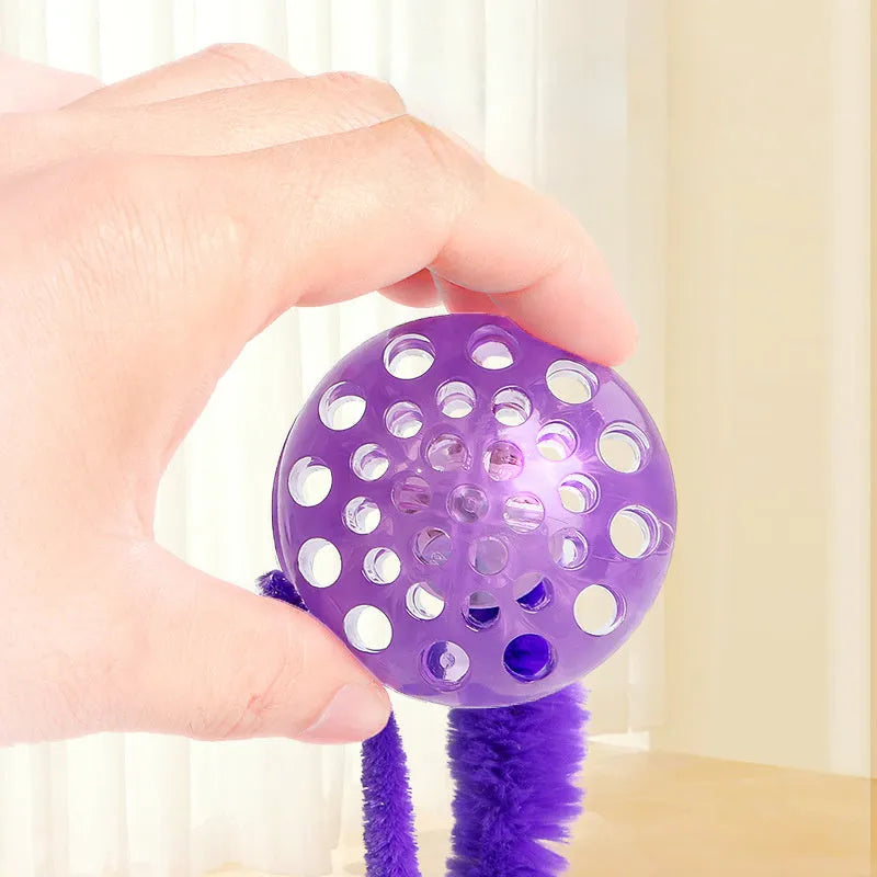Interactive bouncy ball cat toy with worm tail in green, pink, or purple colours