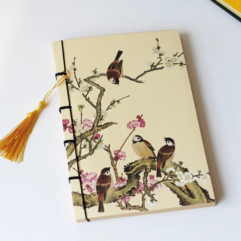 A5 antique wire-bound notebook with glossy embossed cover featuring a retro painting design, shown open.
