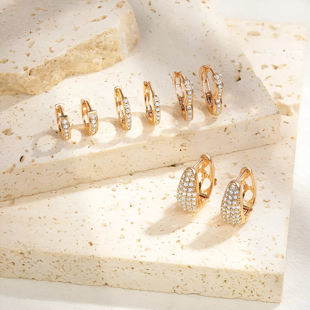 Brass gold plated heart-shaped ear clip earrings with gang drill details on copper construction