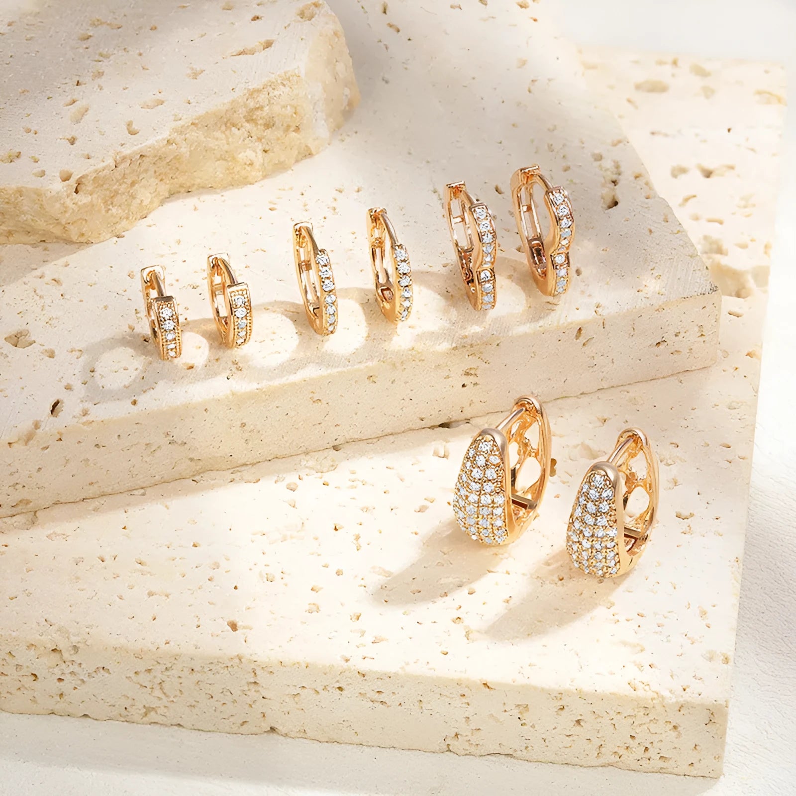 Brass gold plated heart-shaped ear clip earrings with gang drill details on copper construction