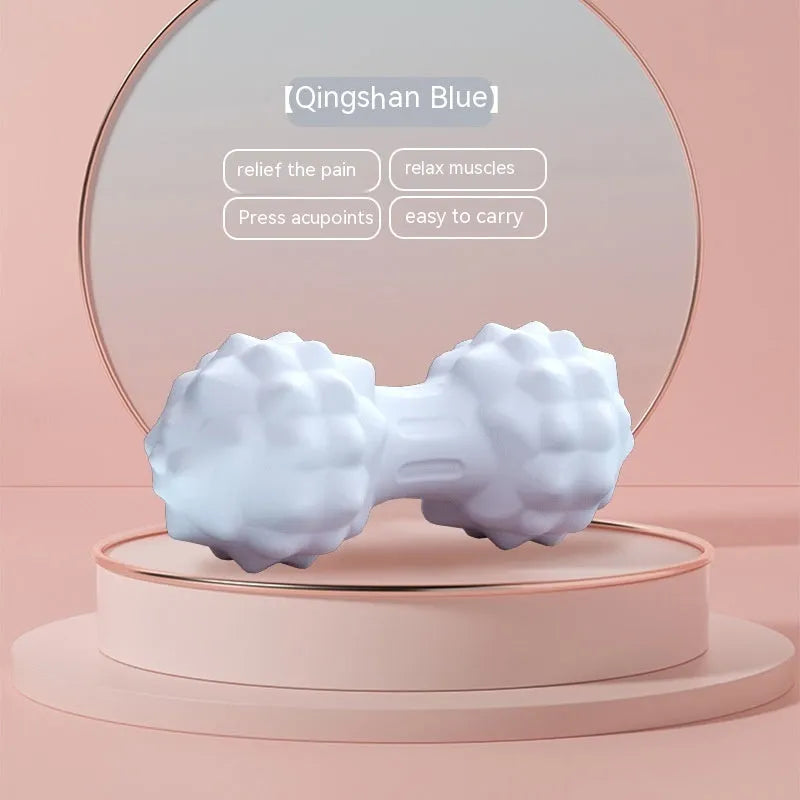 Blue TPR foot massage ball with textured surface shown next to foot for scale