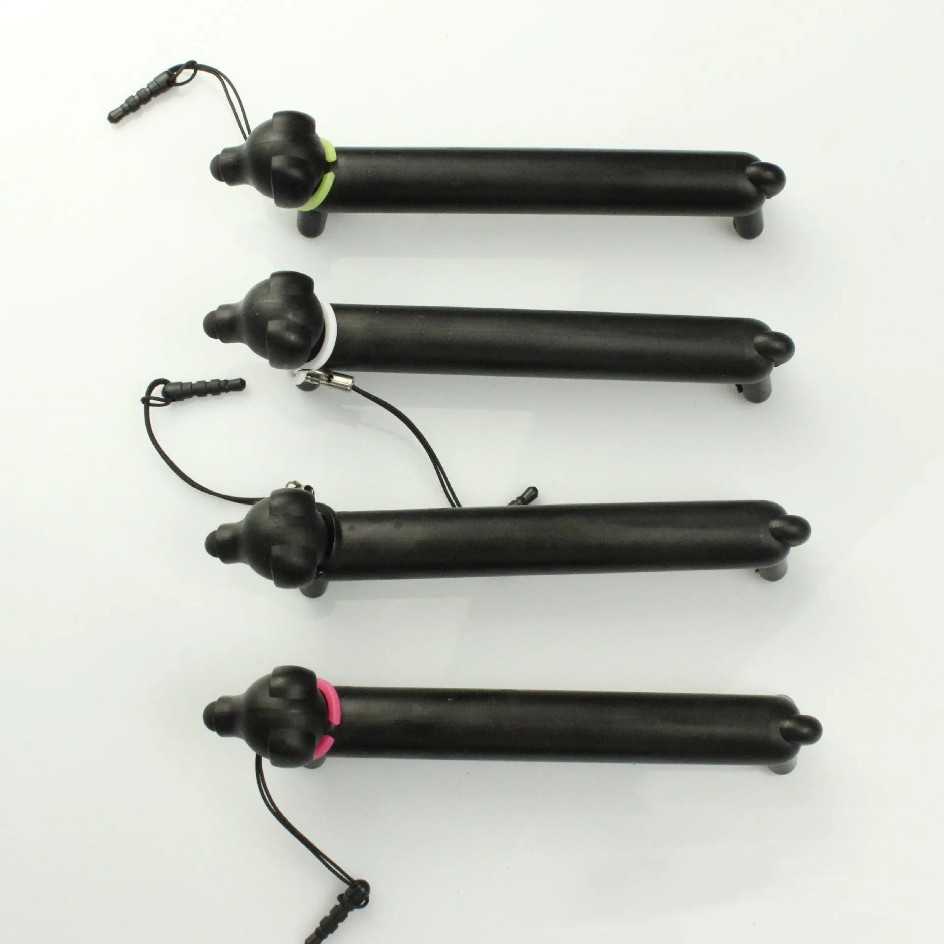 Black dog-shaped touch screen stylus showing dual-length design and phone holder function