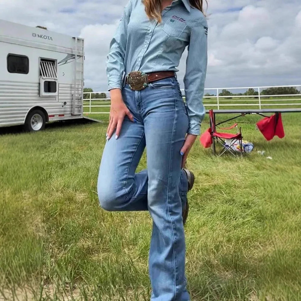 Slim fit blue embroidered jeans with a mid-waist and slightly flared leg on a mannequin.