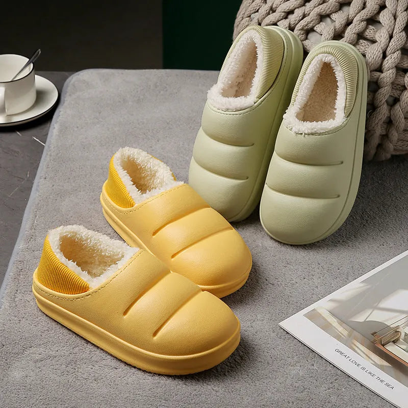 A pair of waterproof EVA couple slippers with a warm plush lining, shown in a green colour option.