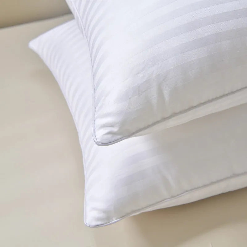 White cotton pillow with satin stripe pattern showing feather and cotton fill in three available sizes