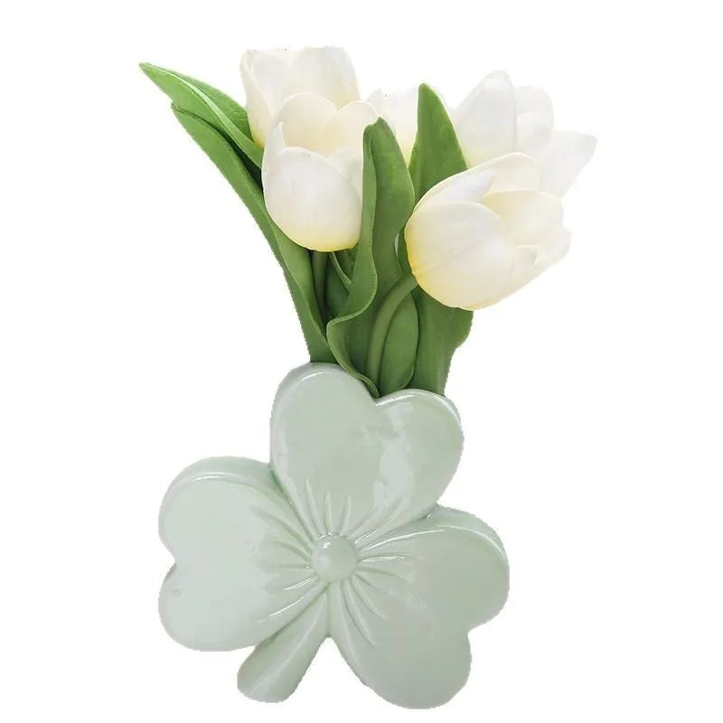 Clover-shaped white porcelain vase in European style on a desktop.