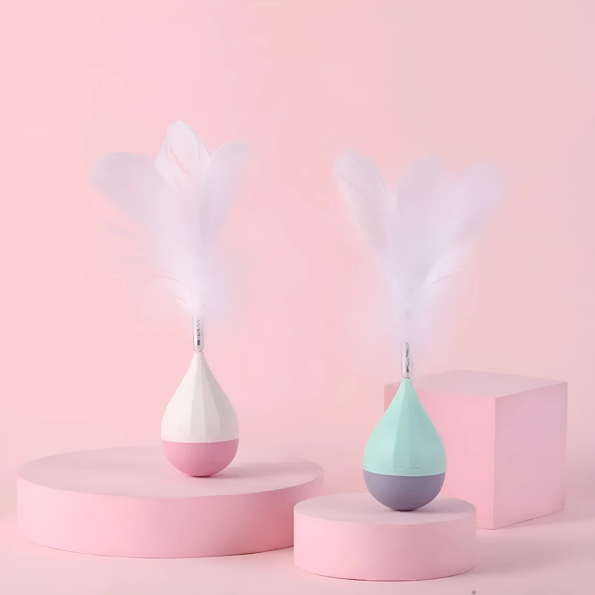 Green and pink feather tumbler cat toy with ABS plastic ball and goose feather attachment
