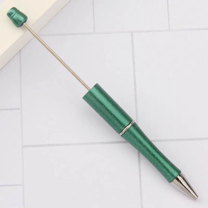 Ballpoint pen with colourful spinning plastic beads on barrel, shown in a gradient purple finish.