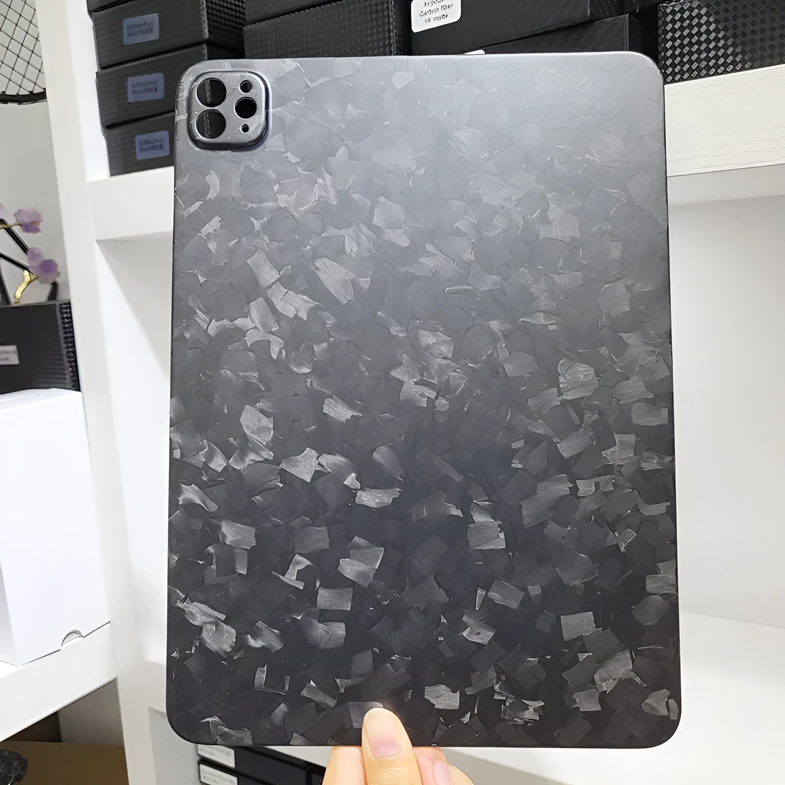 Carbon fibre hard case for Apple iPad Pro 11 showing embossed plaid pattern and matte finish.