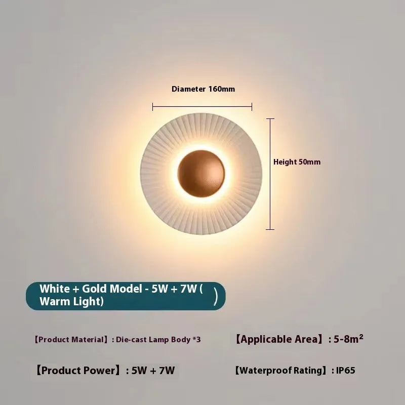 Round aluminium LED wall lamp in outer white and inner gold finish mounted on a wall.