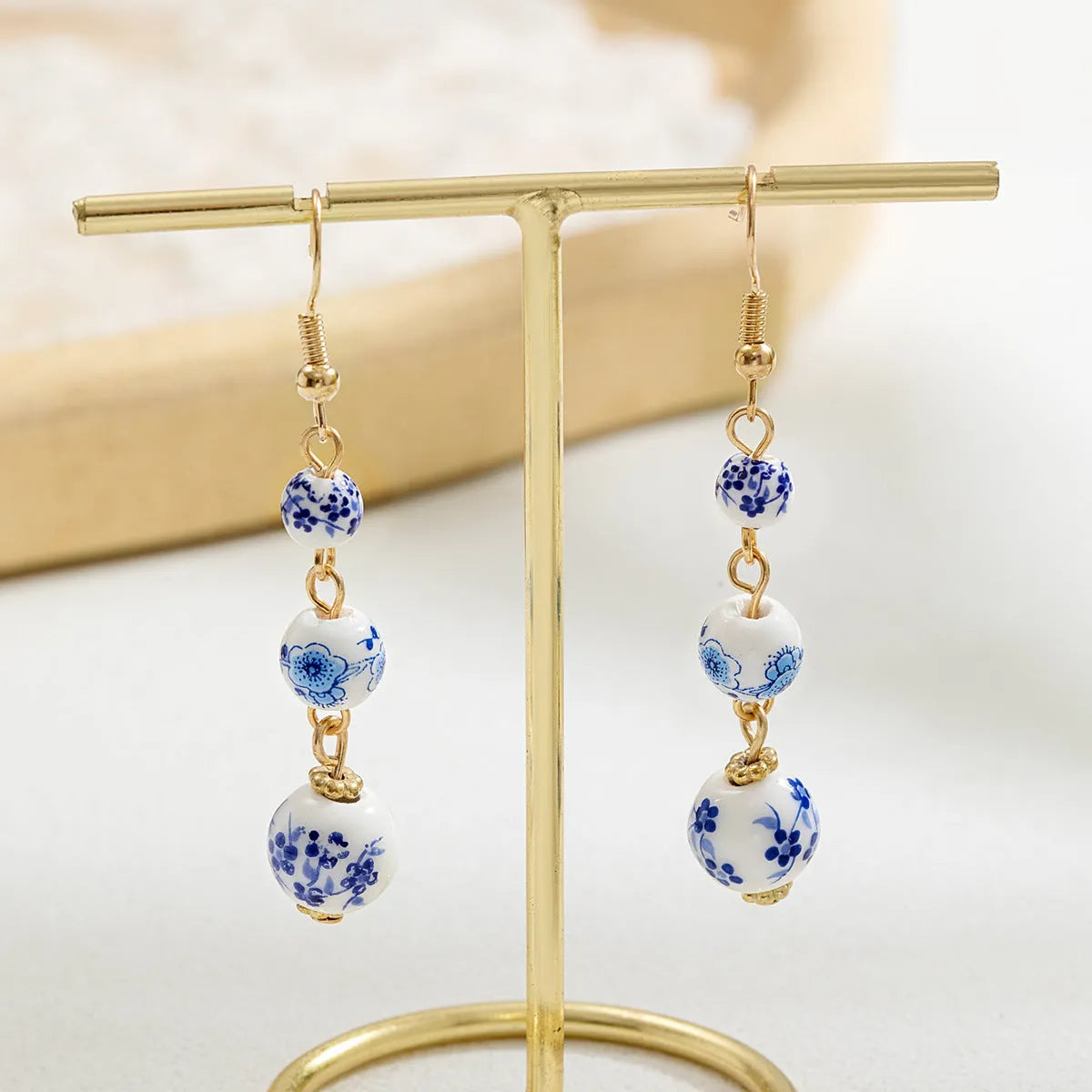 Long blue and white porcelain ceramic bead earrings with geometric Chinese-style design.