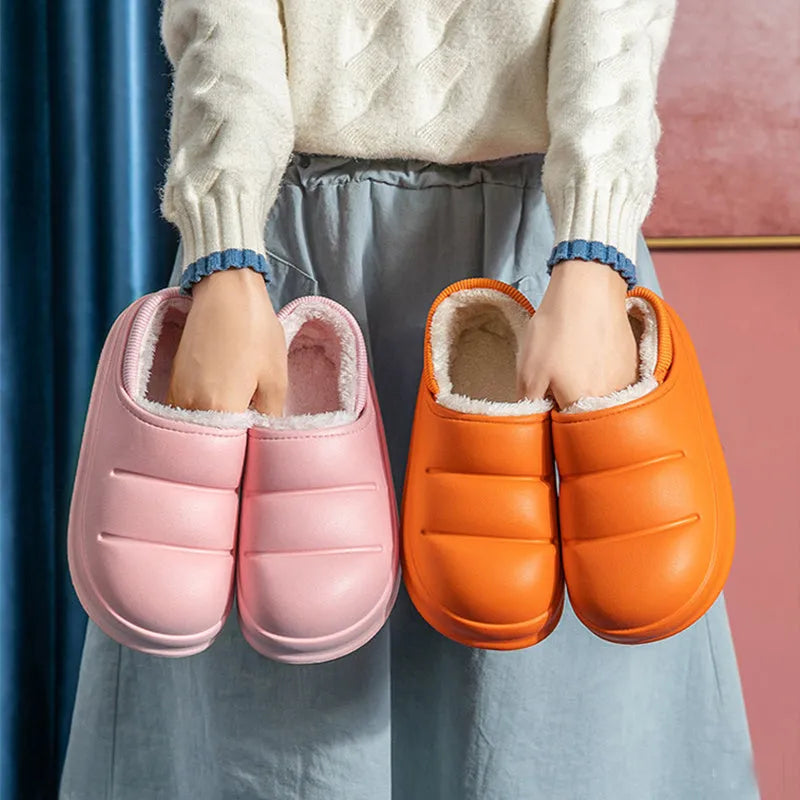 A pair of waterproof EVA couple slippers with a warm plush lining, shown in a green colour option.