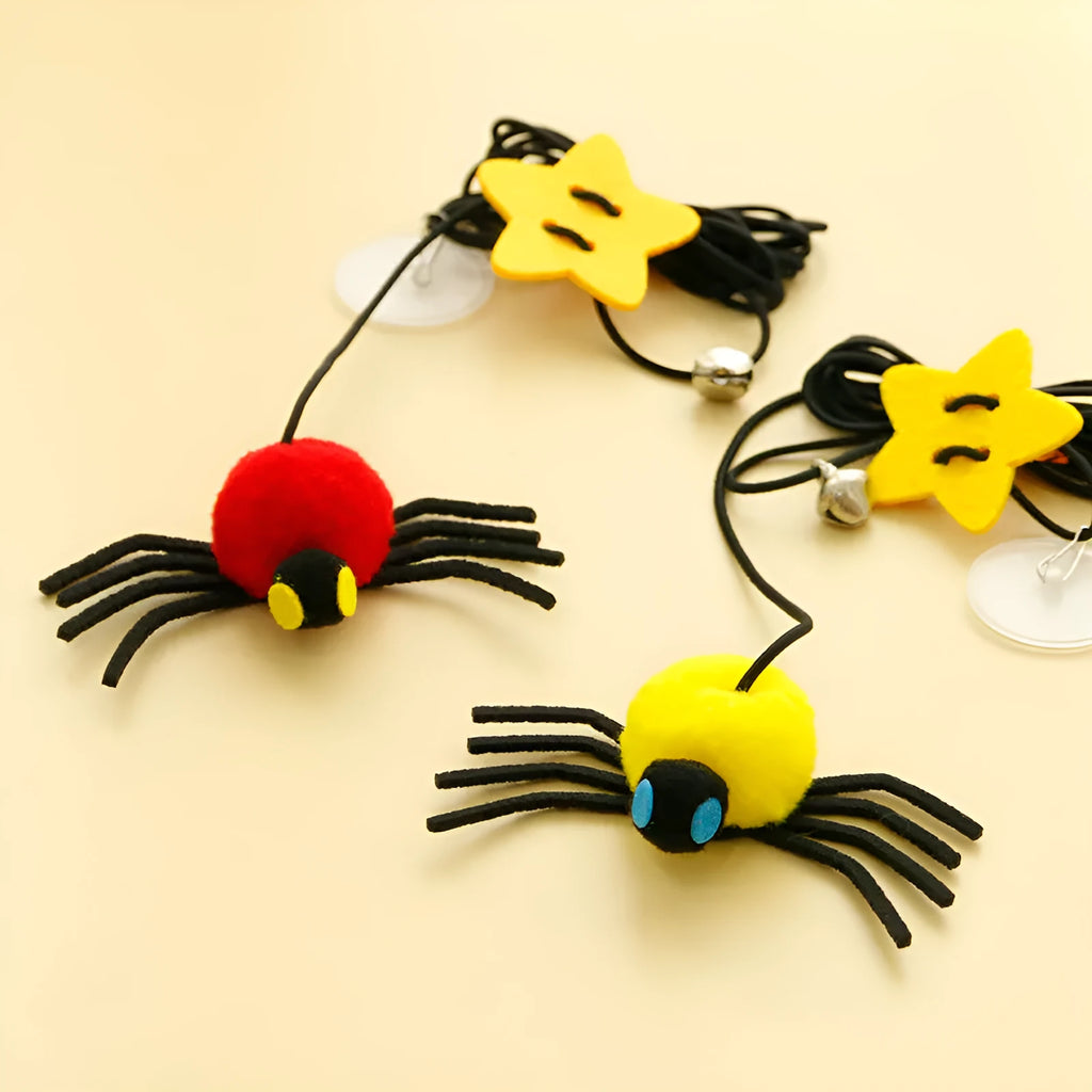 Red and yellow hanging door cat toy with elastic rope, feather, bell, and spider attachments