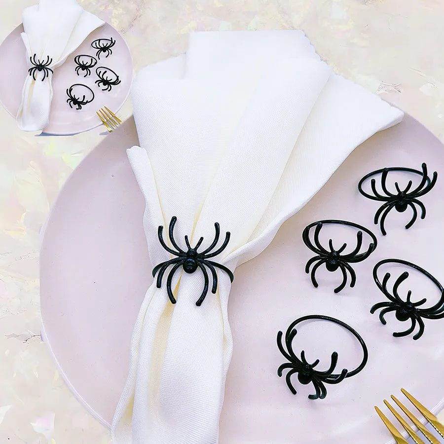 Set of six black alloy napkin rings with spider pattern design for Halloween table decoration