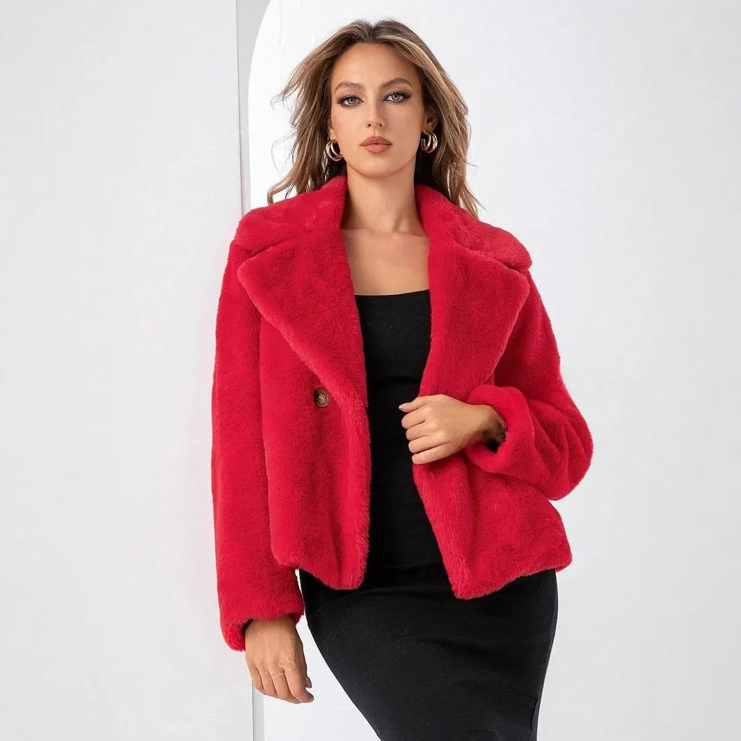 A woman wearing a rose red loose short faux fur coat with regular sleeves.