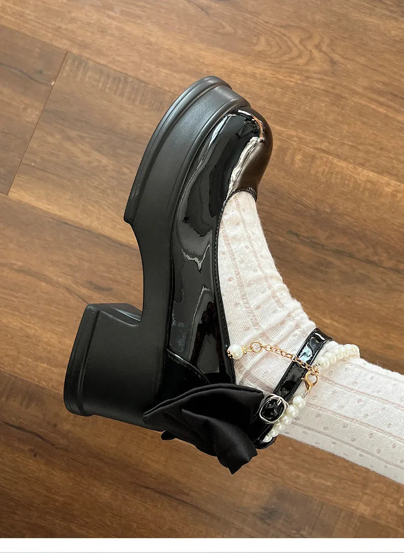 Women's black Mary Jane shoes with chunky heels and round toe design on beige background